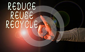 Handwriting text Reduce Reuse Recycle. Concept meaning environmentallyresponsible consumer behavior Finger pointing in the Dark