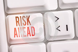 Handwriting text Risk Ahead. Concept meaning A probability or threat of damage, injury, liability, loss White pc keyboard with