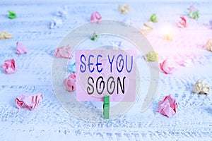 Handwriting text See You Soon. Concept meaning used for saying goodbye to someone and going to meet again soon Green clothespin photo