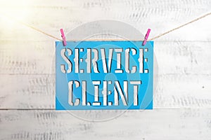 Handwriting text Service Client. Concept meaning Dealing with customers satisfaction and needs efficiently Clothesline clothespin
