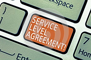 Handwriting text Service Level Agreement. Concept meaning Commitment between a service provider and a client Keyboard