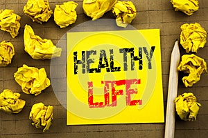 Handwriting text showing Healthy Life. Business concept for Good Health Food written on sticky note paper on the vintage backgroun