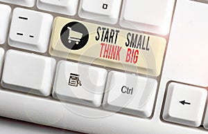 Handwriting text Start Small Think Big. Concept meaning Initiate with few things have something great in mind White pc