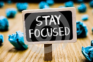 Handwriting text Stay Focused. Concept meaning Be attentive Concentrate Prioritize the task Avoid distractions Blackboard crumpled