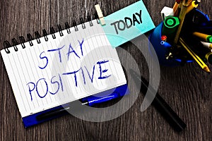 Handwriting text Stay Positive. Concept meaning Engage in Uplifting Thoughts Be Optimistic and Real Open notebook clothespin holdi