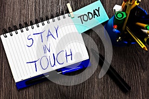 Handwriting text Stay In Touch. Concept meaning Keep Connected thru Phone Letters Visit Email Social Media Open notebook