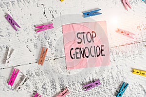 Handwriting text Stop Genocide. Concept meaning to put an end on the killings and atrocities of showing Colored clothespin