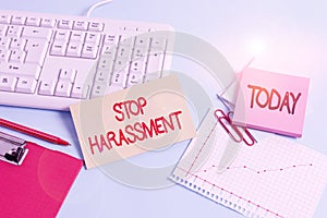 Handwriting text Stop Harassment. Concept meaning Prevent the aggressive pressure or intimidation to others Paper blue desk