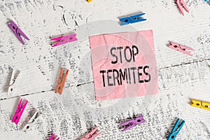 Handwriting text Stop Termites. Concept meaning prevent a small tropical insect from damaging the woods Colored clothespin