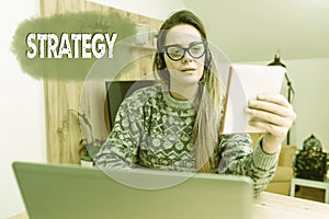 Handwriting text Strategy. Business approach action plan or strategy designed to achieve an overall goal Abstract
