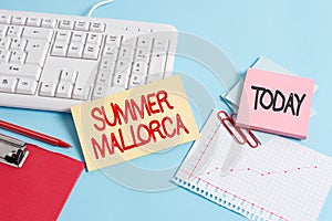 Handwriting text Summer Mallorca. Concept meaning Spending the holiday season in the Balearic islands of Spain Paper blue desk