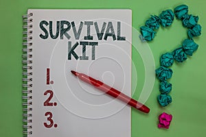 Handwriting text Survival Kit. Concept meaning Emergency Equipment Collection of items to help someone Notebook marker crumpled pa