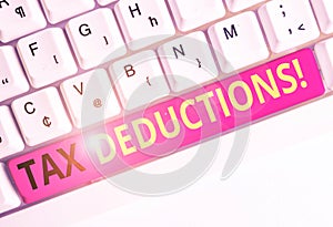 Handwriting text Tax Deductions. Concept meaning reduction income that is able to be taxed of expenses White pc keyboard