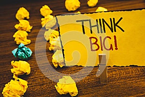 Handwriting text Think Big Motivational Call. Concept meaning Have great ideas Dream of something amazingClothespin holding Yellow