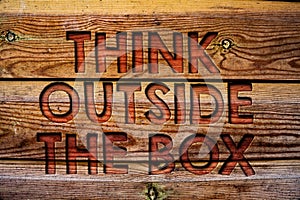 Handwriting text Think Outside The Box. Concept meaning Thinking of new and creative solution leads to success Wooden background v