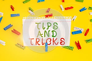 Handwriting text Tips And Tricks. Concept meaning helpful advices that makes certain action easier to do Colored