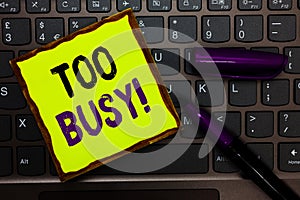 Handwriting text Too Busy. Concept meaning No time to relax no idle time for have so much work or things to do Yellow paper keyboa photo