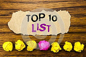 Handwriting text Top 10 Ten List. Concept for Success ten list Written on sticky note paper reminder, wooden background with sti