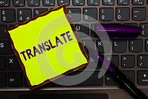 Handwriting text Translate. Concept meaning Another word with same equivalent meaning of a target language Yellow paper keyboard I photo