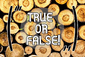 Handwriting text True Or False. Concept meaning Decide between a fact or telling a lie Doubt confusion Wooden background