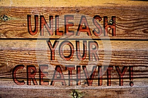Handwriting text Unleash Your Creativity Call. Concept meaning Develop Personal Intelligence Wittiness Wisdom Wooden background vi