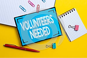 Handwriting text Volunteers Needed. Concept meaning need work or help for organization without being paid Flashy School photo