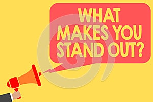 Handwriting text What Makes You Stand Out question. Concept meaning asking someone about his qualities Man holding megaphone louds