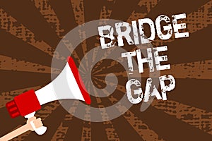 Handwriting text writing Bridge The Gap. Concept meaning Overcome the obstacles Challenge Courage Empowerment Man holding megaphon