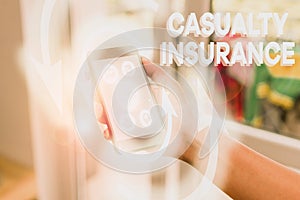Handwriting text writing Casualty Insurance. Concept meaning overage against loss of property or other liabilities photo