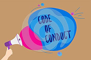 Handwriting text writing Code Of Conduct. Concept meaning Ethics rules moral codes ethical principles values respect Man holding M