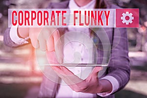 Handwriting text writing Corporate Flunky. Concept meaning someone who works obediently for another demonstrating in