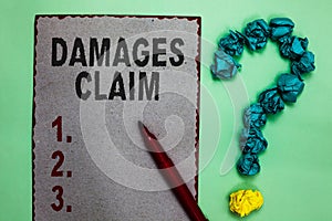 Handwriting text writing Damages Claim. Concept meaning Demand Compensation Litigate Insurance File Suit Gray paper marker crumple