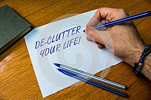 Handwriting text writing De Clutter Your Life. Concept meaning remove unnecessary items from untidy or overcrowded