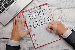 Handwriting text writing Debt Relief. Concept meaning partial or total remission of it especially those by countries.