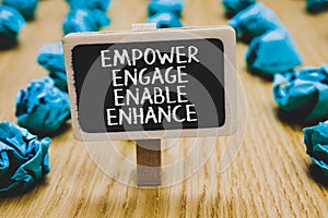 Handwriting text writing Empower Engage Enable Enhance. Concept meaning Empowerment Leadership Motivation Engagement Stand blackbo