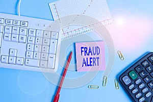 Handwriting text writing Fraud Alert. Concept meaning security alert placed on credit card account for stolen identity Paper blue