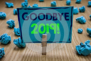 Handwriting text writing Goodbye 2019. Concept meaning New Year Eve Milestone Last Month Celebration Transition Clothespin holding