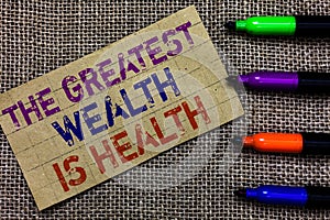 Handwriting text writing The Greatest Wealth Is Health. Concept meaning being in good health is the prize Take care Paperboard com