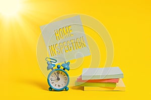 Handwriting text writing Home Inspection. Concept meaning Examination of the condition of a home related property Metal alarm photo