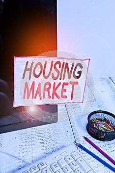 Handwriting text writing Housing Market. Concept meaning number of houses and apartments available in particular area Note paper