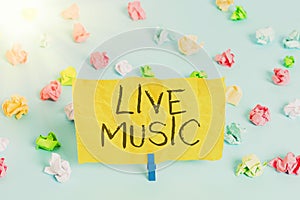 Handwriting text writing Live Music. Concept meaning performance given by one or more singers or instrumentalists Colored crumpled photo