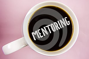 Handwriting text writing Mentoring. Concept meaning To give advice or support to a younger less experienced person written on Blac