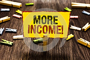 Handwriting text writing More Income. Concept meaning Additional money receives for an exchange of good or services Clothespin hol