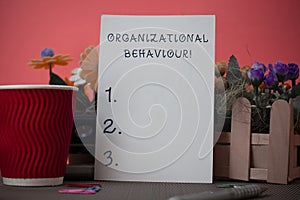 Handwriting text writing Organizational Behaviour. Concept meaning the study of the way showing interact within groups photo