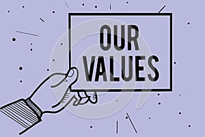 Handwriting text writing Our Values. Concept meaning list of morals companies or individuals commit to do them Man hand holding pa