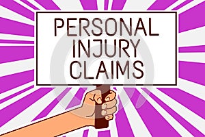 Handwriting text writing Personal Injury Claims. Concept meaning being hurt or injured inside work environment Man hand holding po