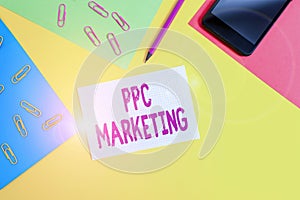 Handwriting text writing Ppc Marketing. Concept meaning using search engine advertising to make clicks to your website Paper