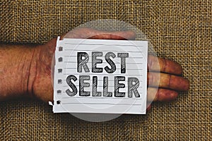 Handwriting text writing Rest Seller. Concept meaning one feature or the perceived benefit good which makes it unique Man hand hol