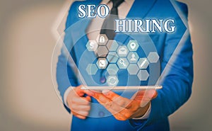 Handwriting text writing Seo Hiring. Concept meaning employing a specialist will develop content to include keywords