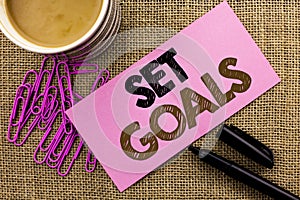 Handwriting text writing Set Goals. Concept meaning Target Planning Vision Dreams Goal Idea Aim Target Motivation written on Pink